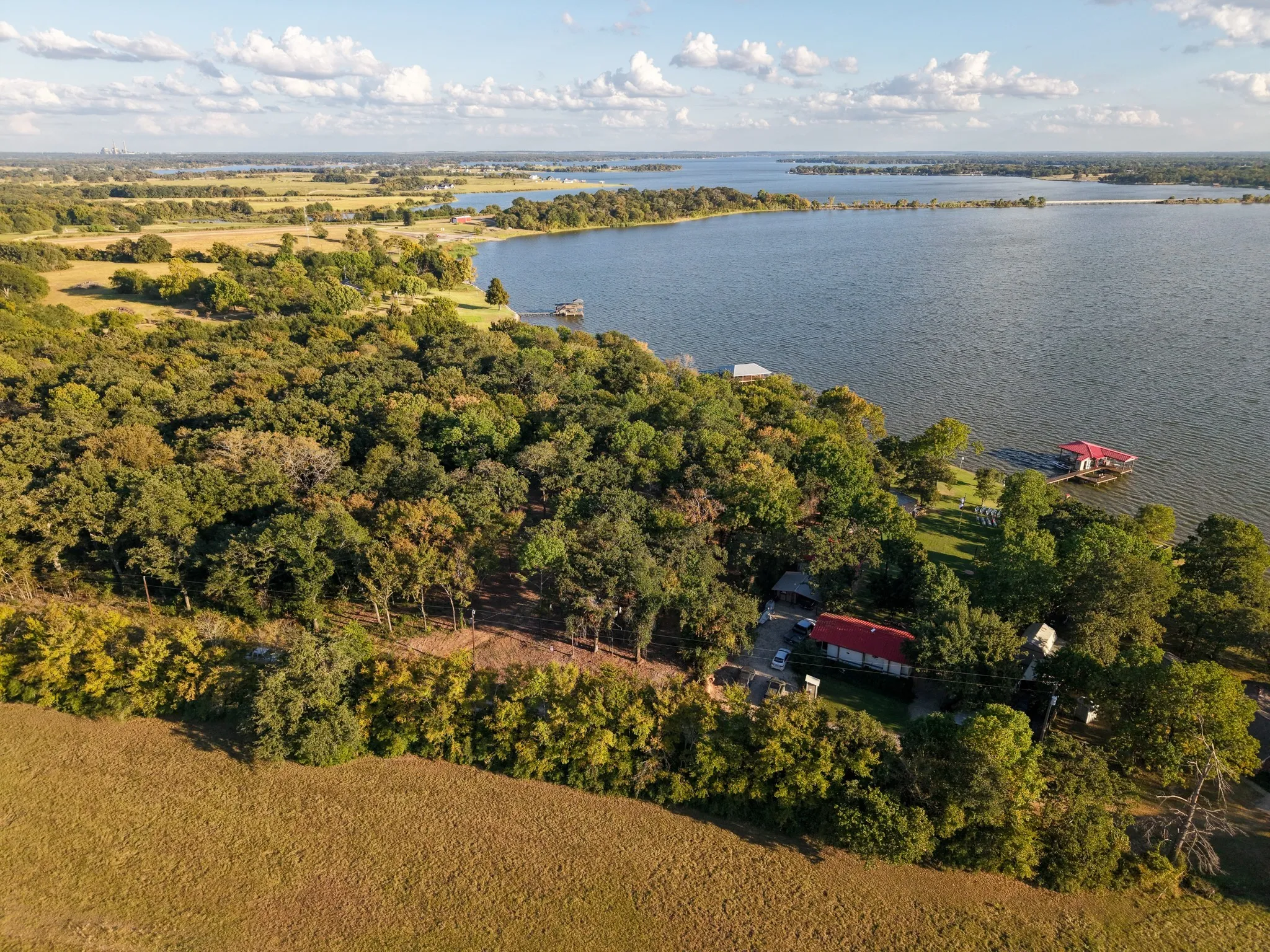 Aerial view of property and surrounding area featuring a large body of water