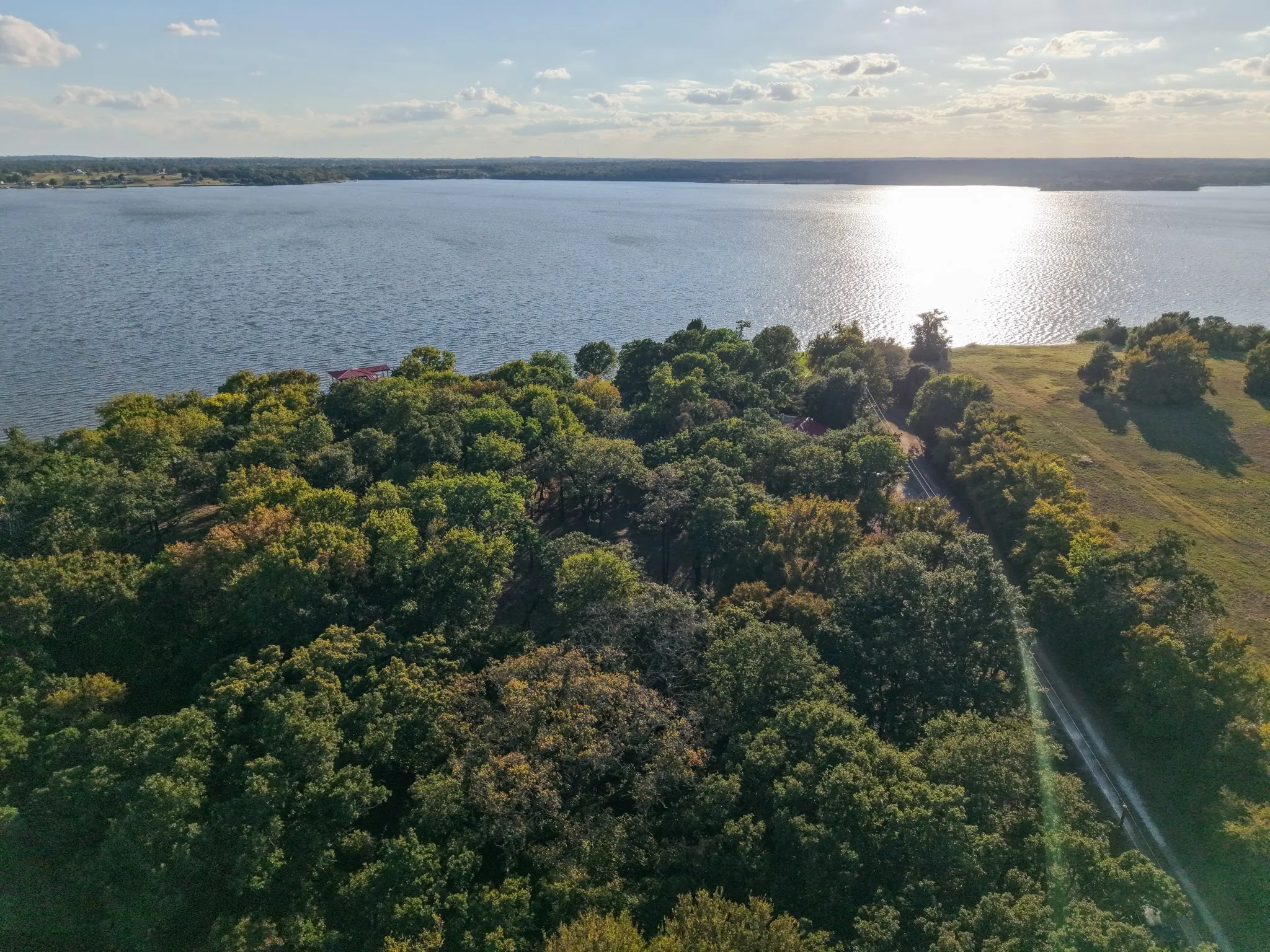 Aerial view of property's location with a large body of water