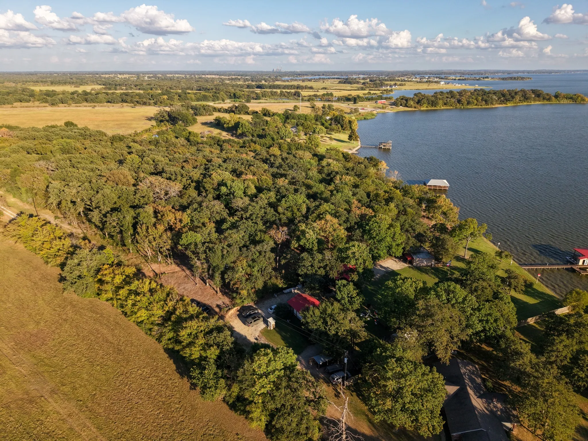 Aerial view of property's location with a large body of water