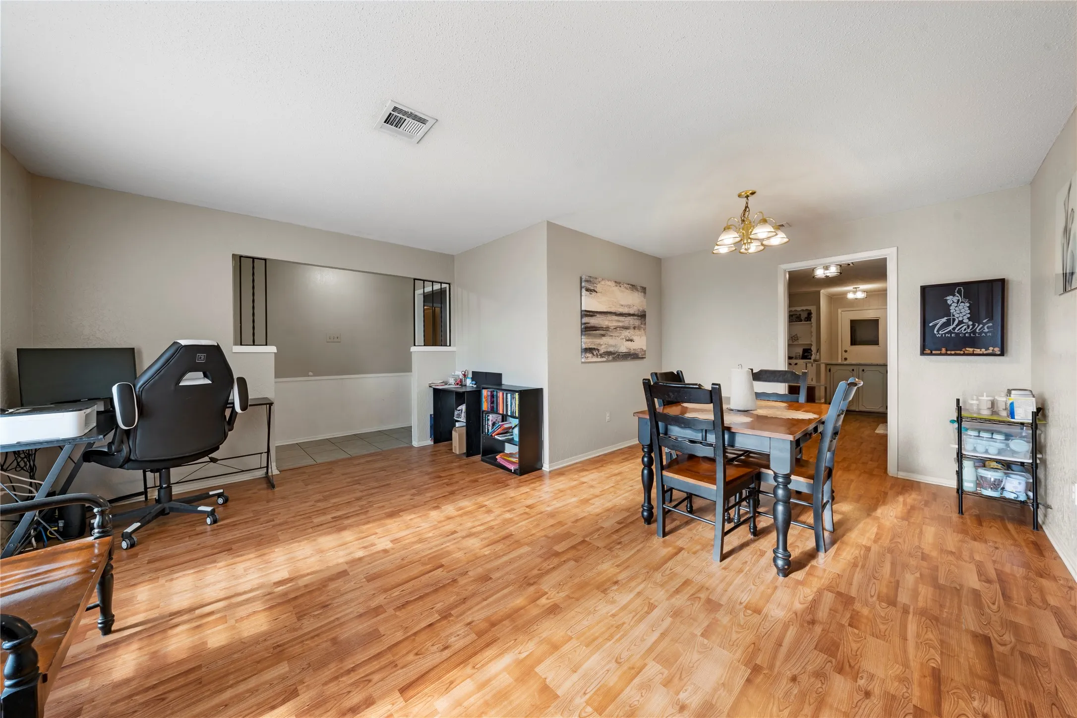Dining space featuring light wood-style floors and a chandelier