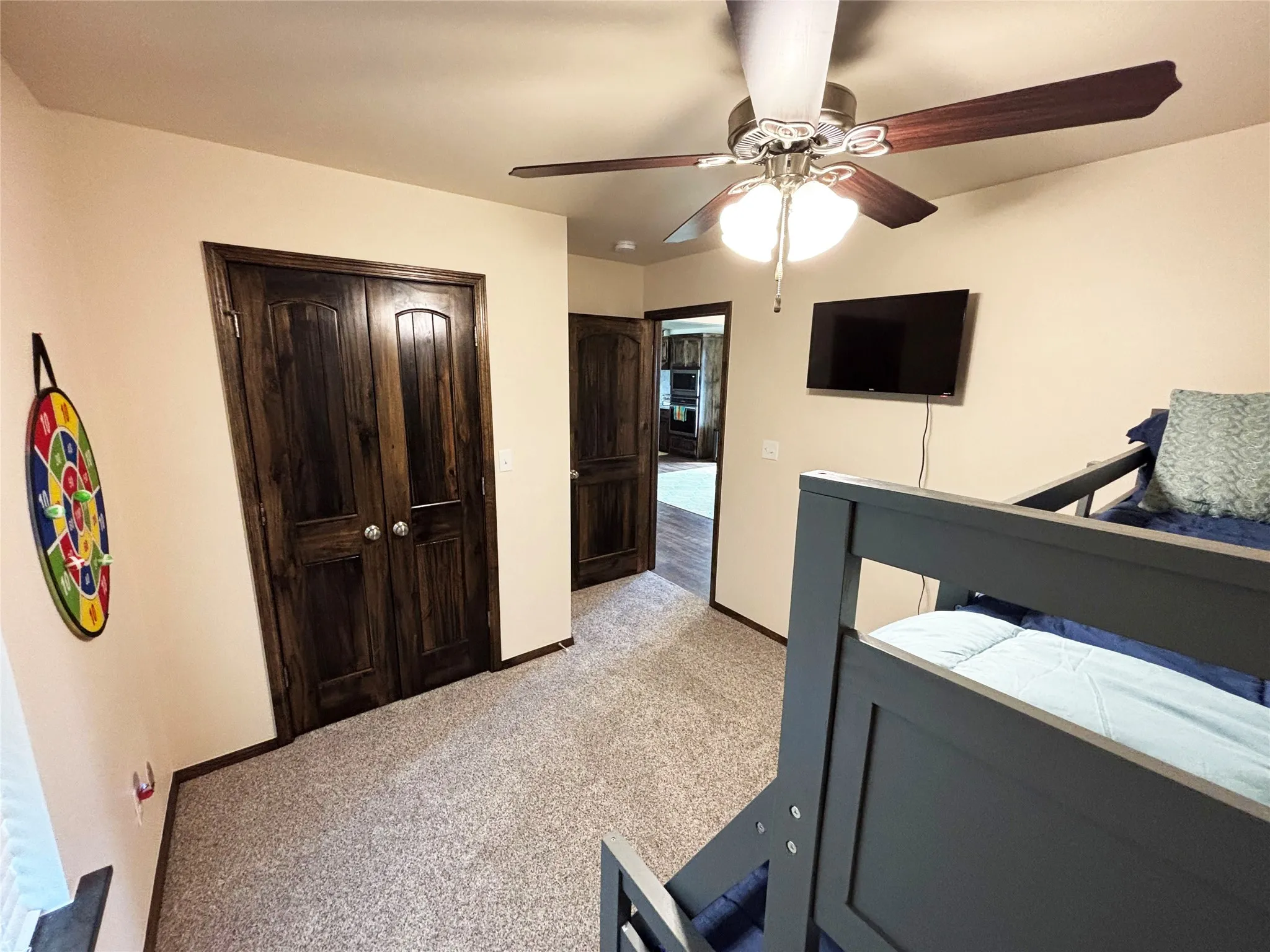 Bedroom featuring a closet, light carpet, and ceiling fan