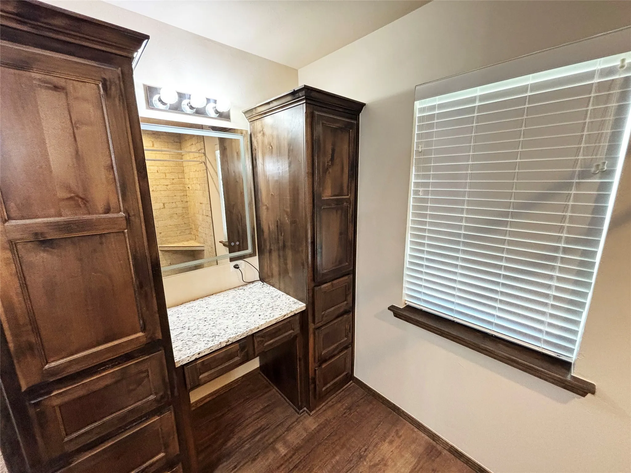 Bathroom with dark wood-type flooring and vanity