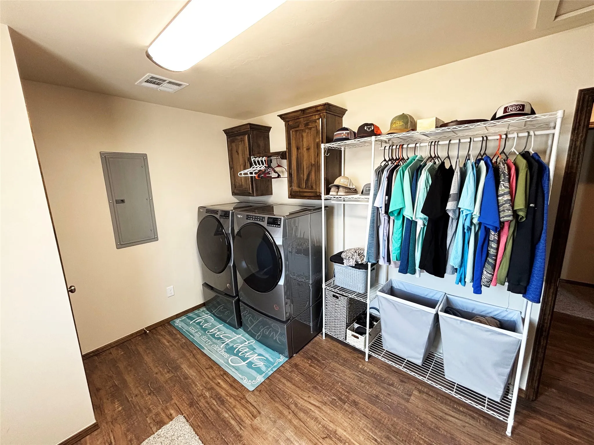 Washroom with electric panel, washing machine and dryer, and cabinet space
