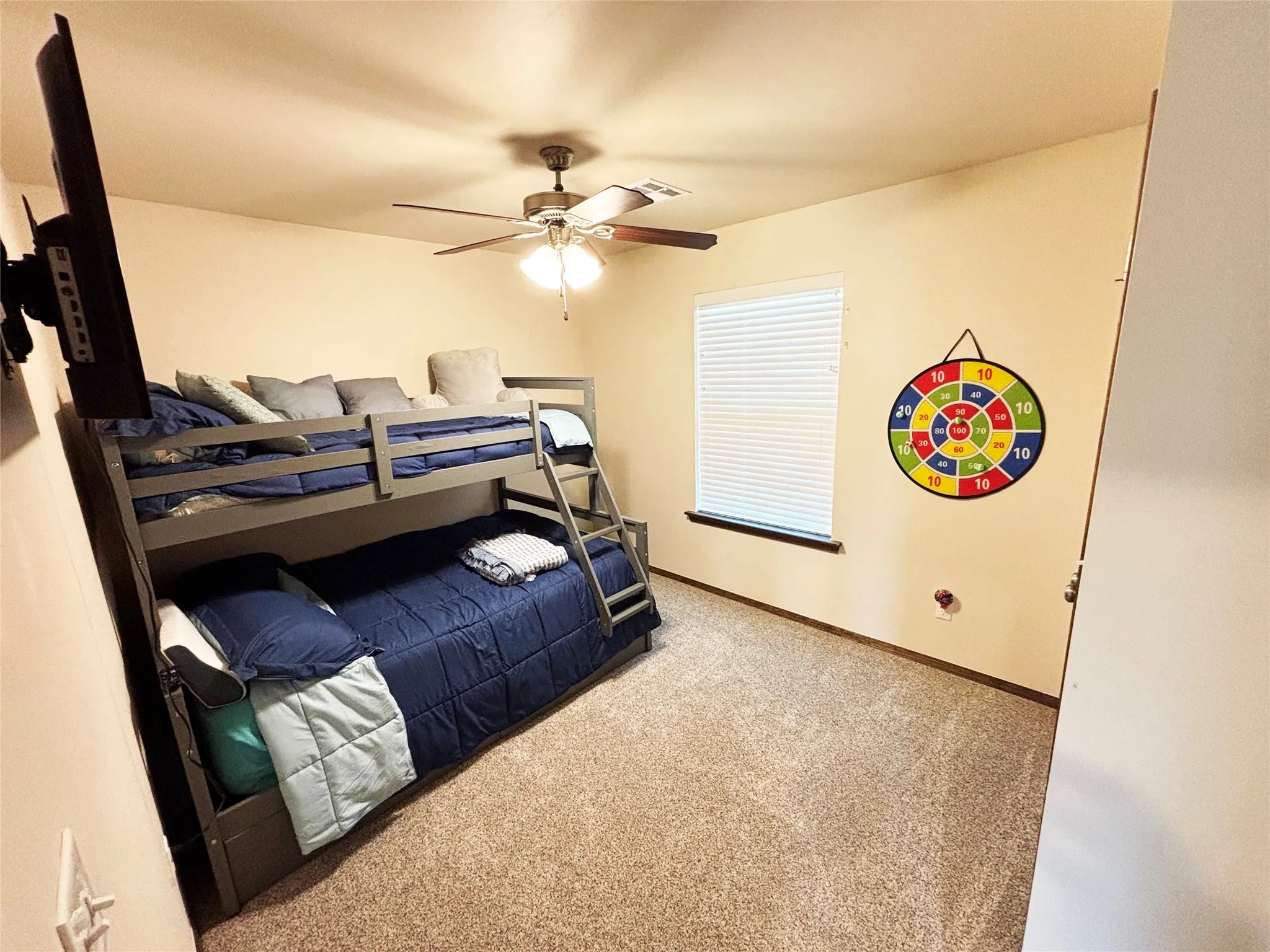 Bedroom featuring light carpet and ceiling fan
