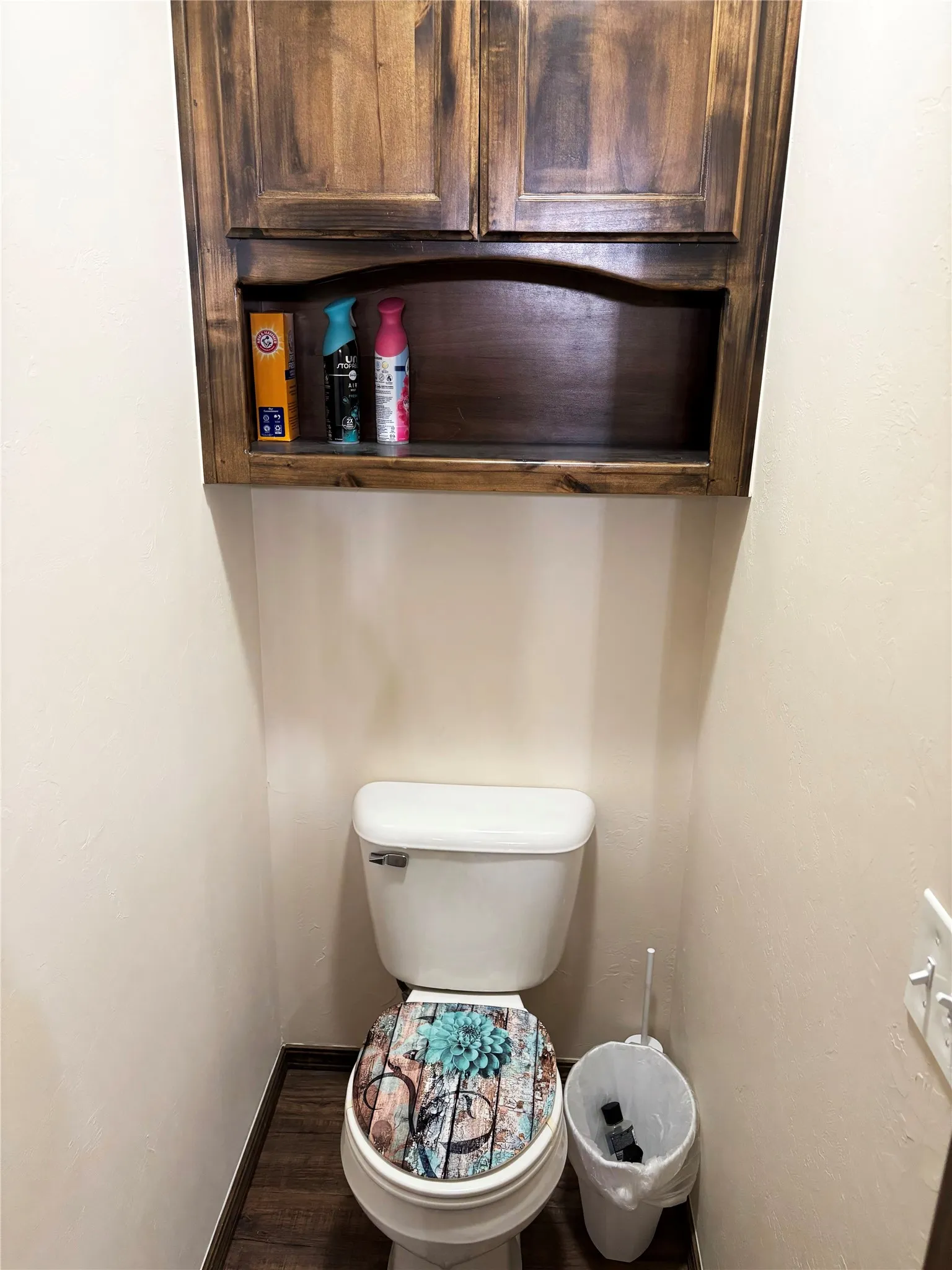 Bathroom with baseboards and dark wood-style flooring