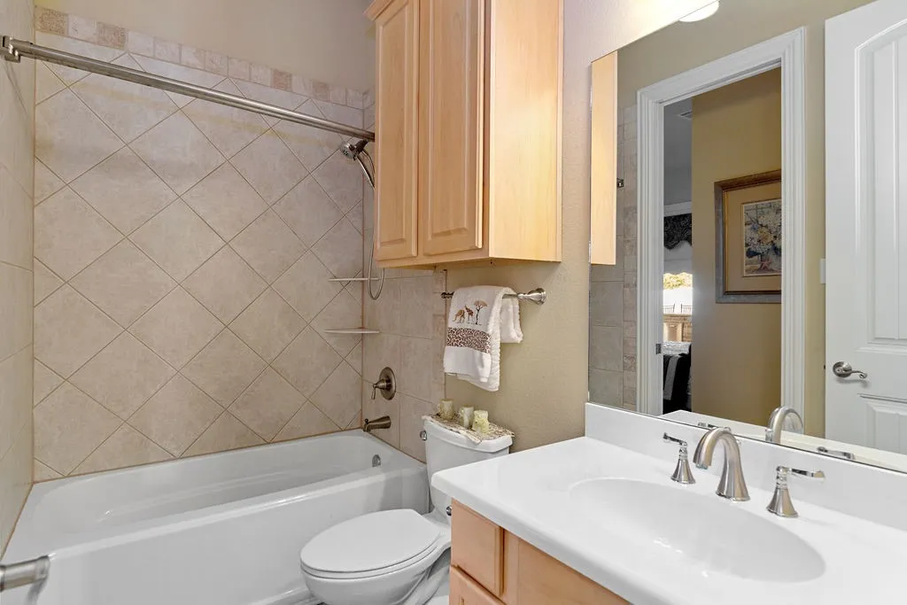 Bathroom with vanity and bathing tub / shower combination
