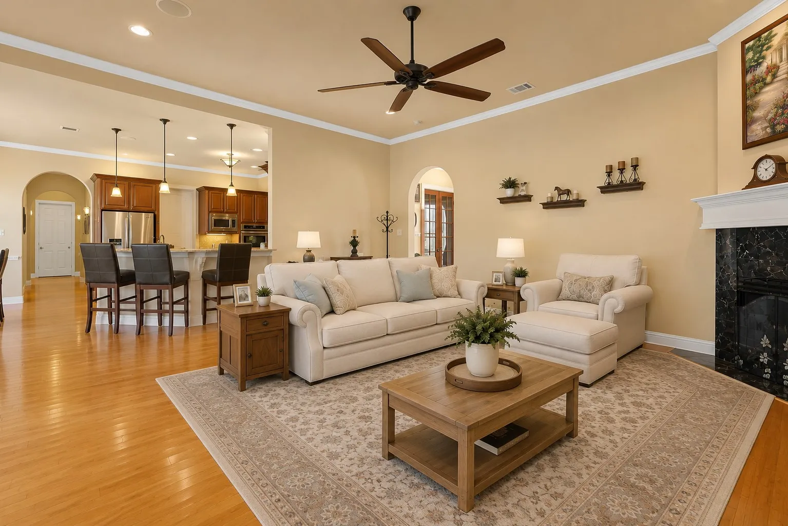 Hardwood flooring, crown molding, a built-in fireplace with a stone surround, recessed lighting, and a ceiling fan