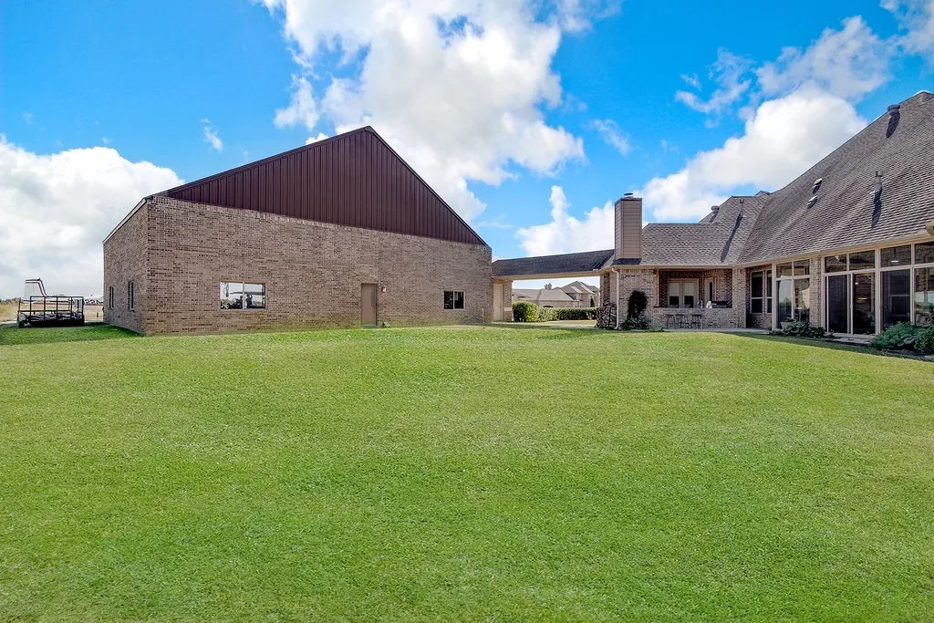 View of grassy yard with a patio area