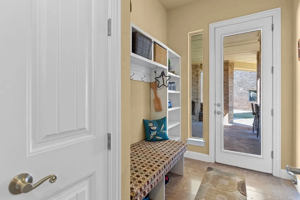 Mudroom featuring light tile patterned flooring and baseboards