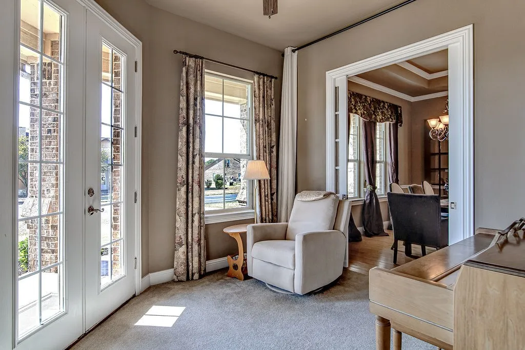 Sitting room with carpet, a chandelier, and french doors