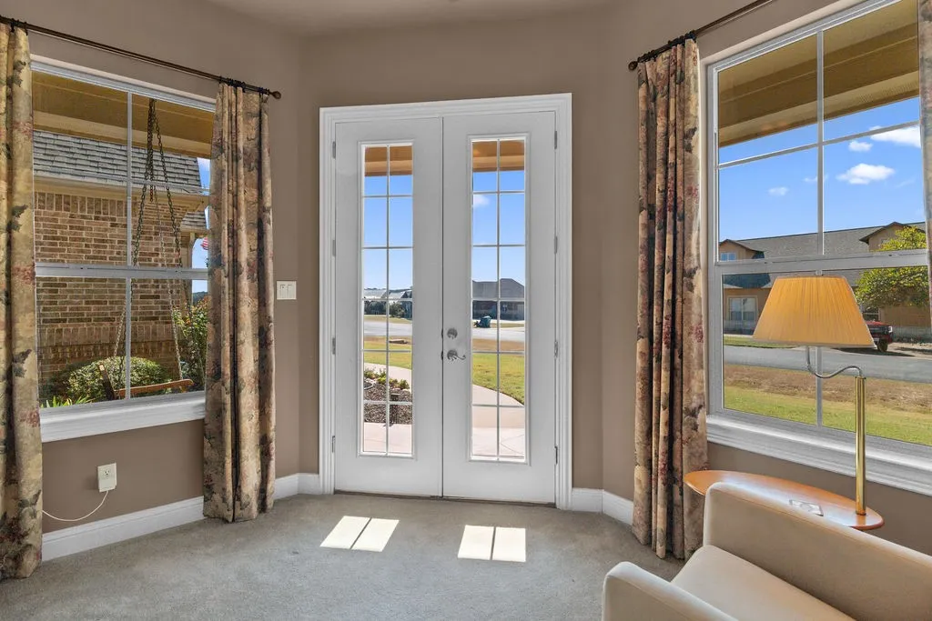 Doorway with french doors and carpet flooring