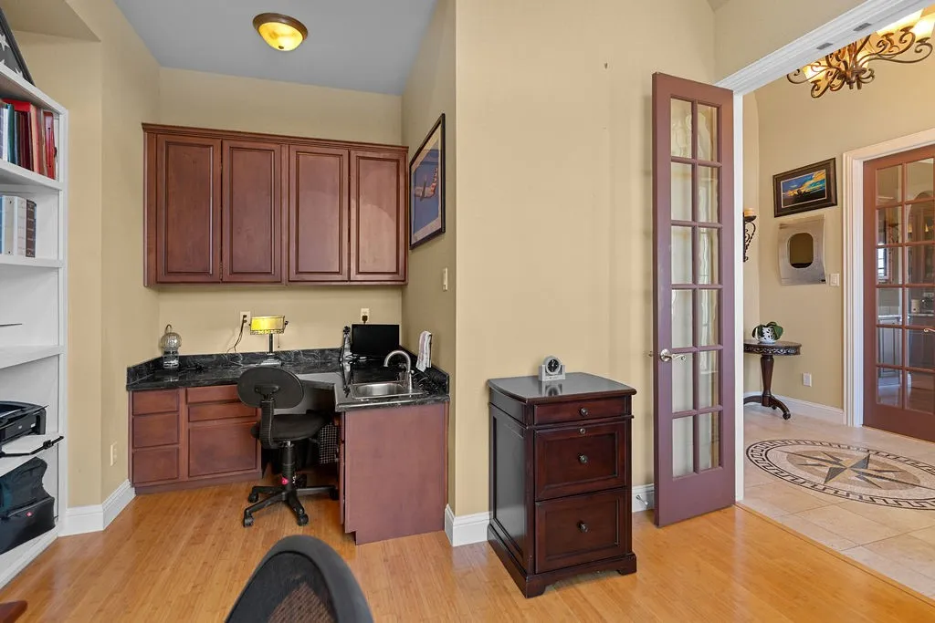 Office space with light wood-style flooring and french doors