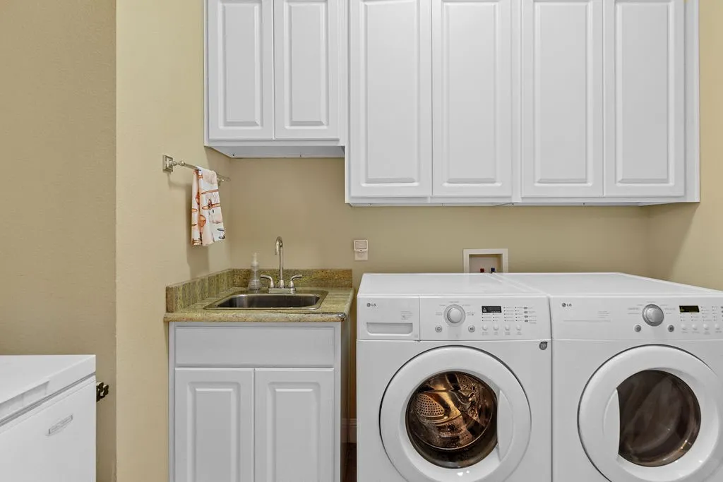 Laundry room featuring separate washer and dryer and cabinet space