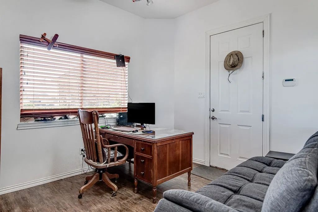 Office space featuring wood finished floors and baseboards