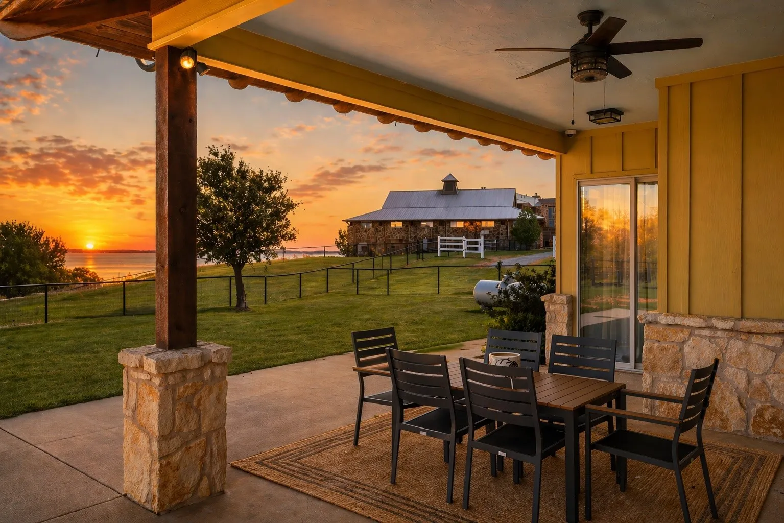 Covered patio with a stone base column and exposed wood beam