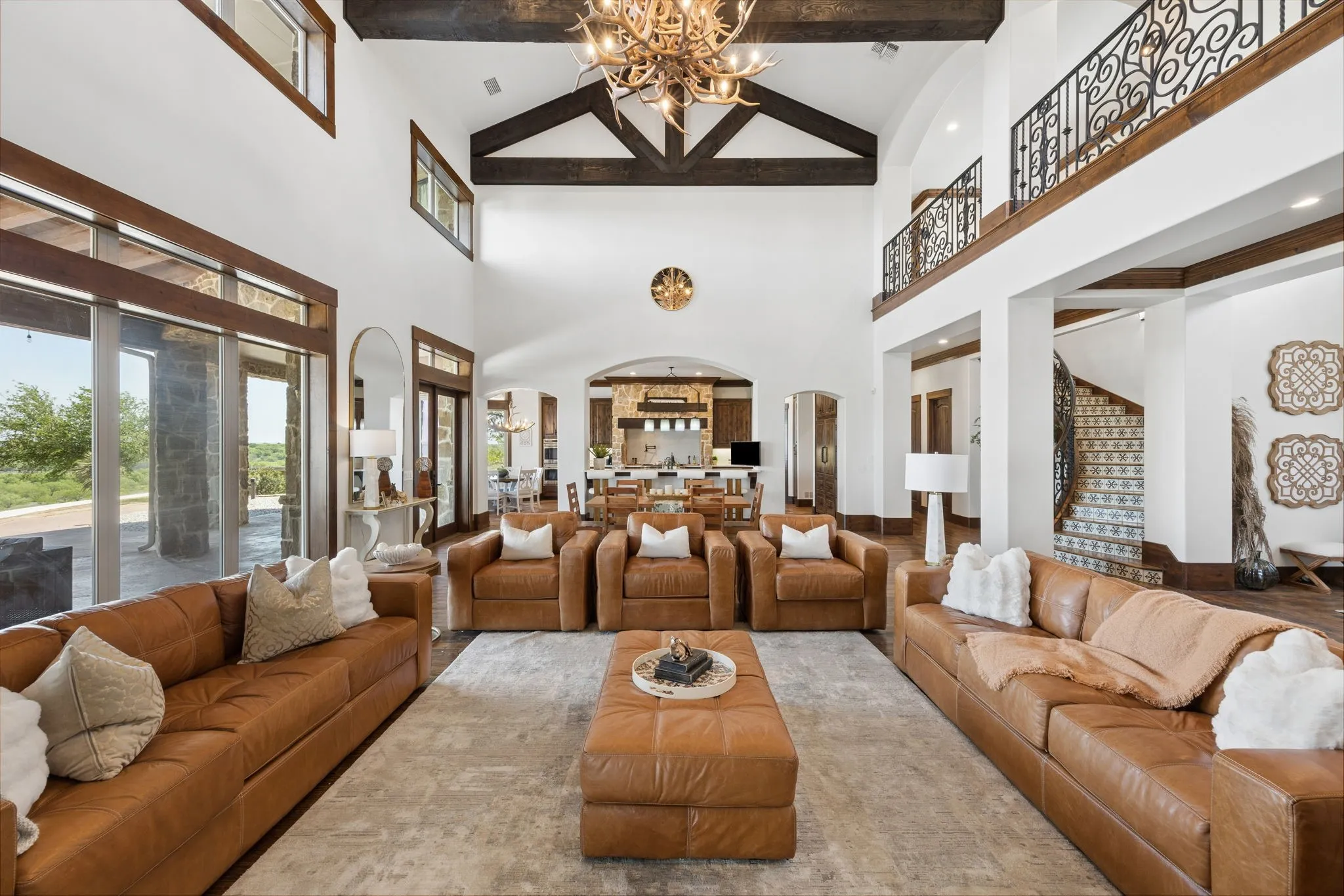 Vaulted ceilings with exposed wood beams define this expansive great room