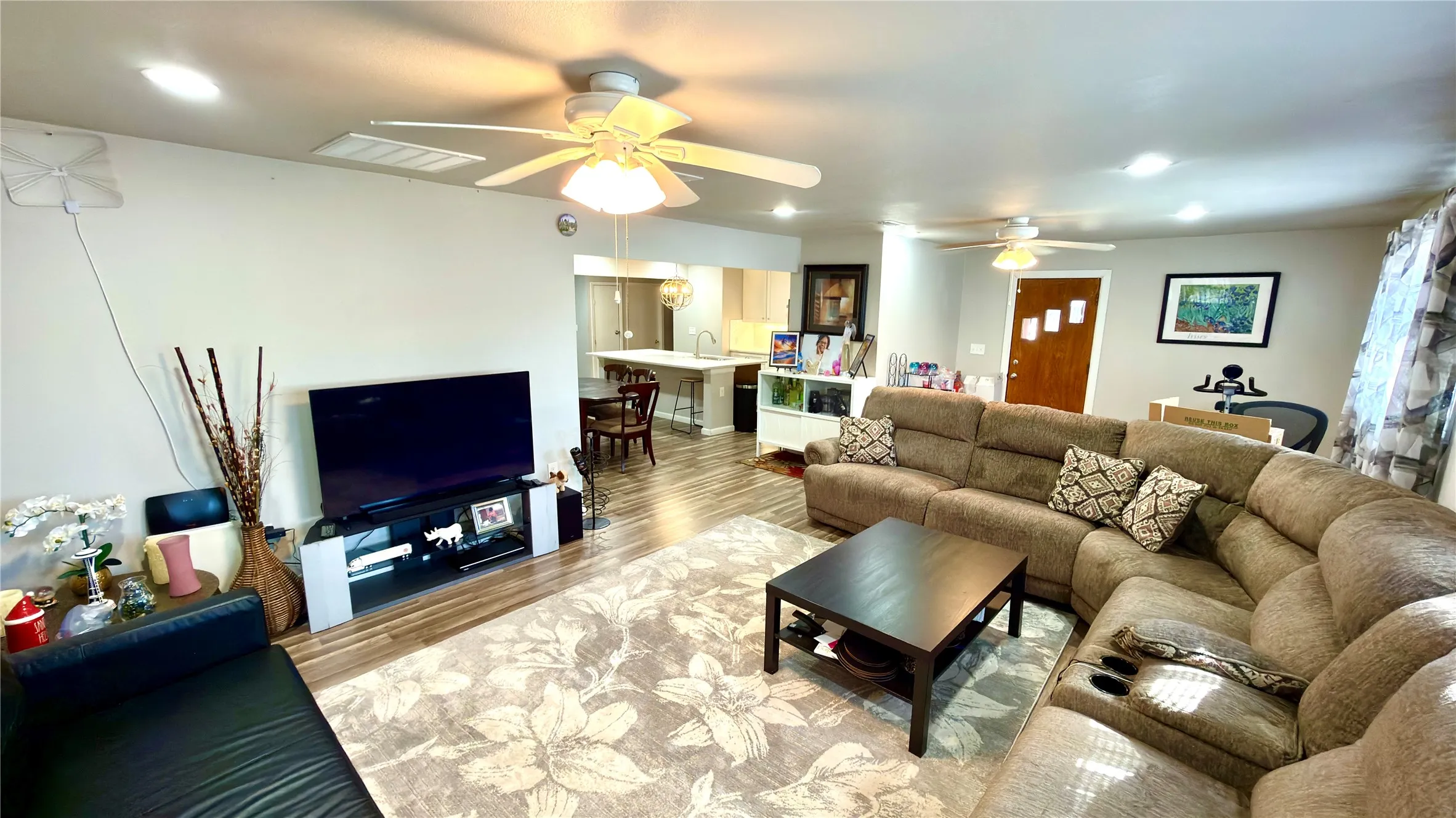 Living area with  floors and a ceiling fan