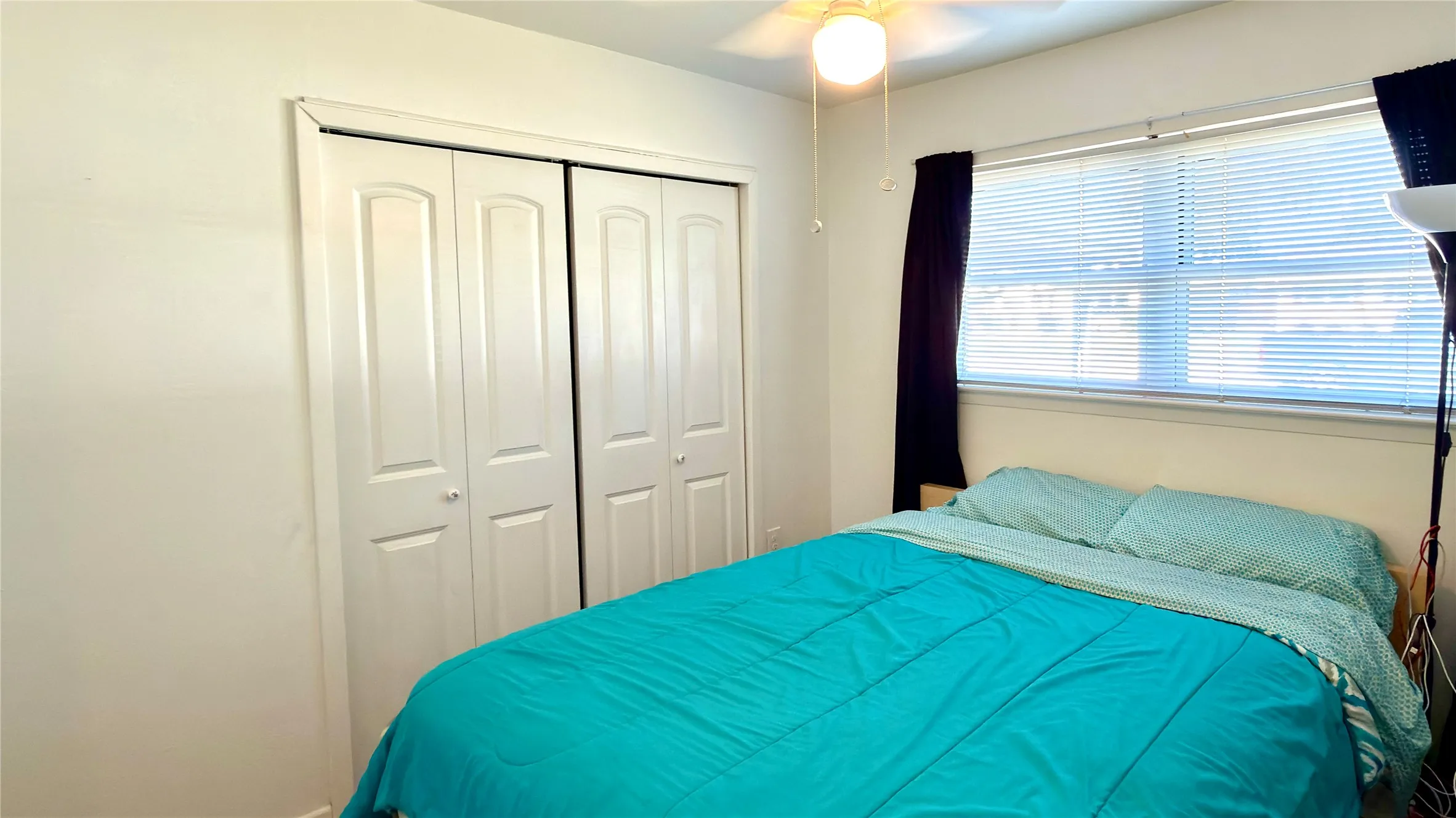 Bedroom Bedroom featuring light wood floors with a closet and ceiling fan