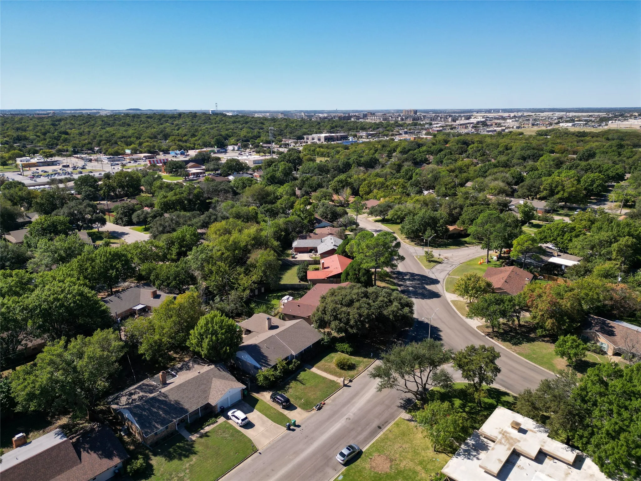 Aerial view of property's location featuring nearby suburban area