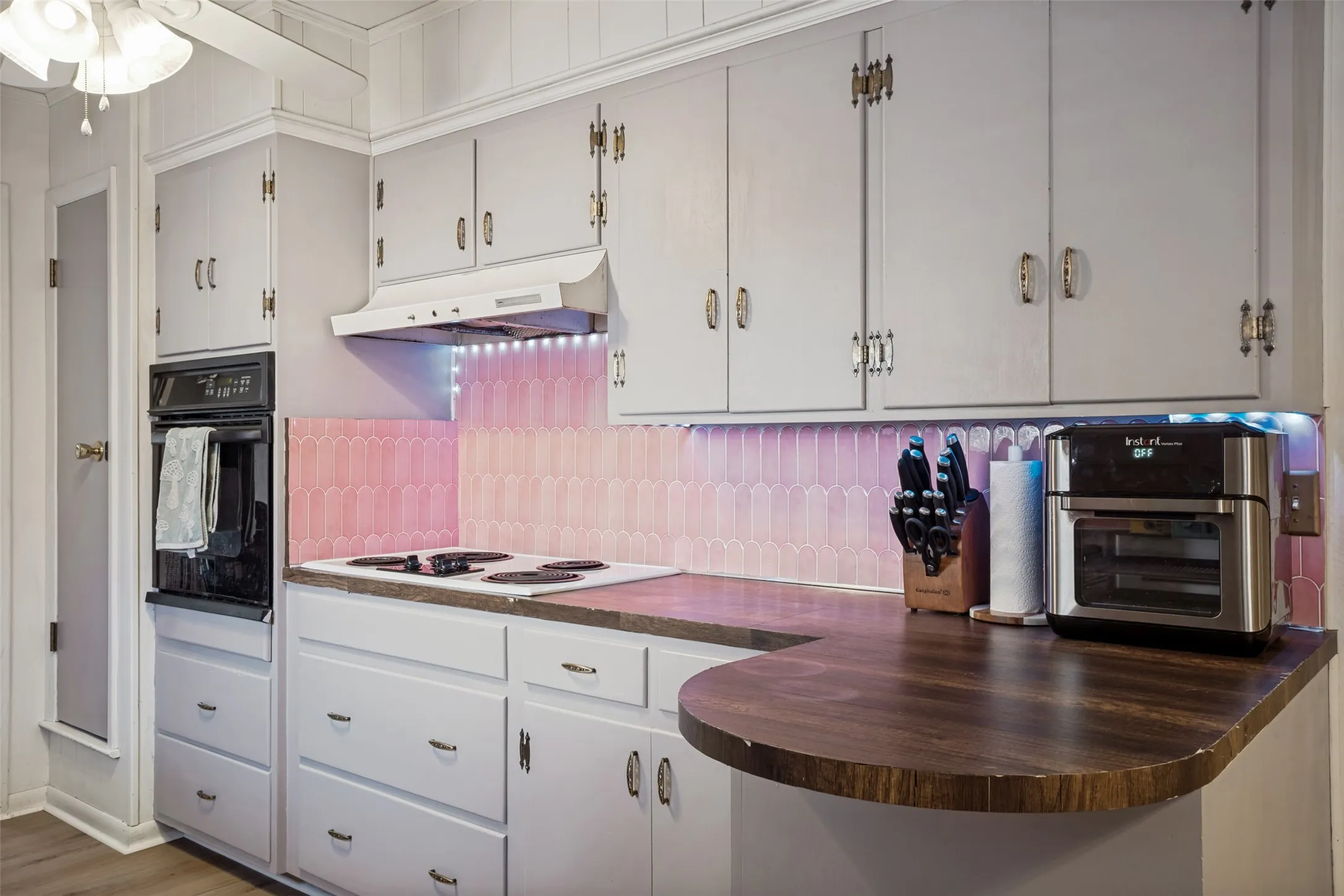 Light-toned cabinetry with brass-finish hardware