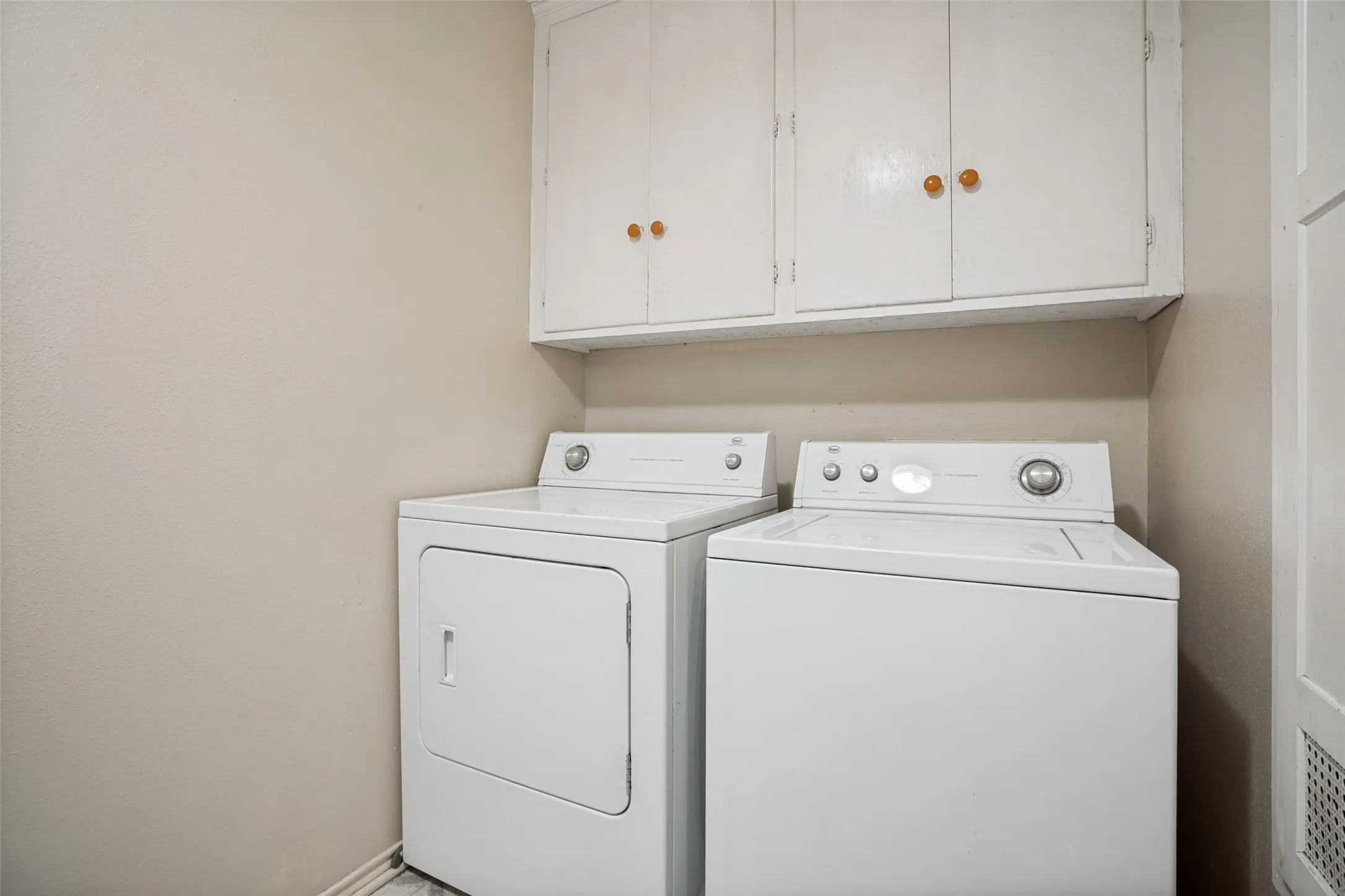 White upper cabinetry with wood-finish knobs
