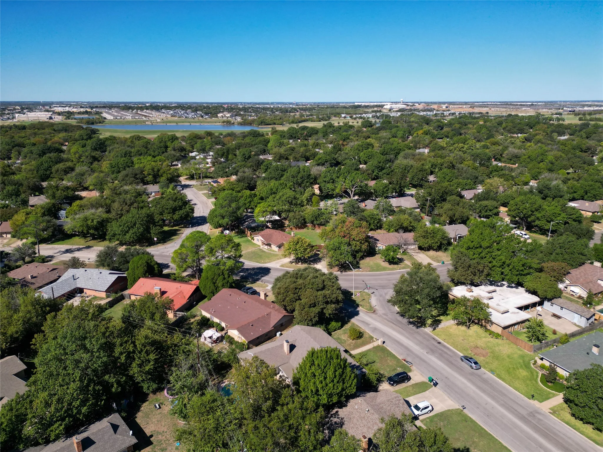 Aerial view of residential area featuring a nearby body of water