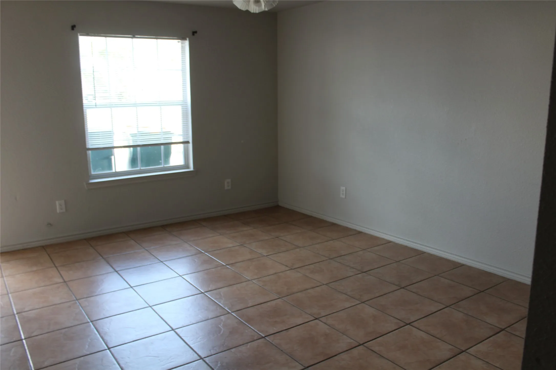 Empty room with light tile patterned floors