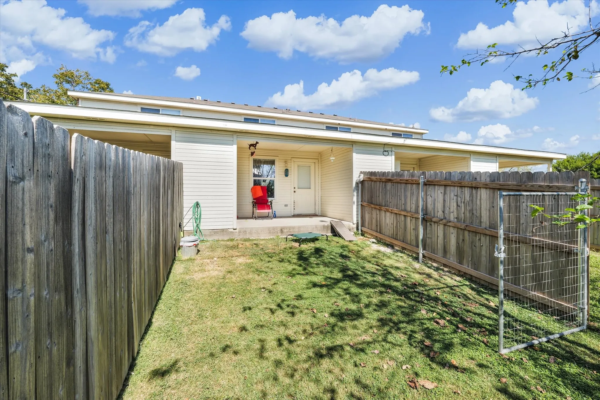 Back of property with a fenced backyard and a patio