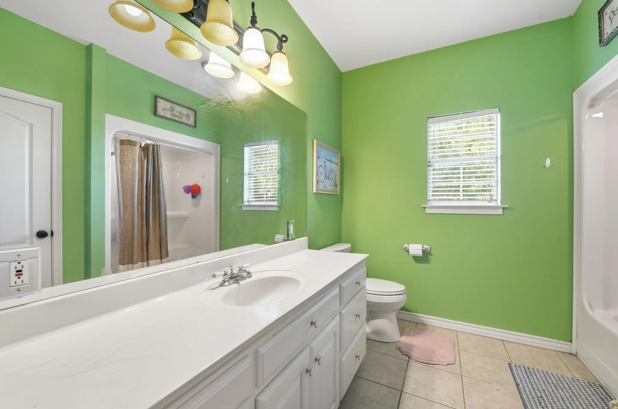 Full bathroom with vanity and light tile patterned floors