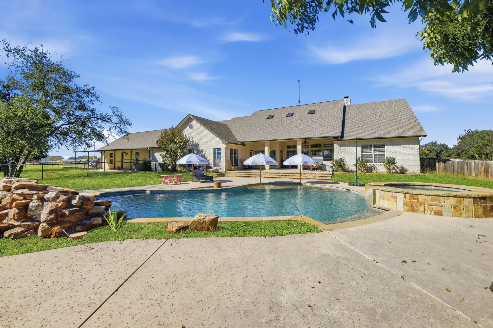 View of pool featuring a patio area and a pool with connected hot tub