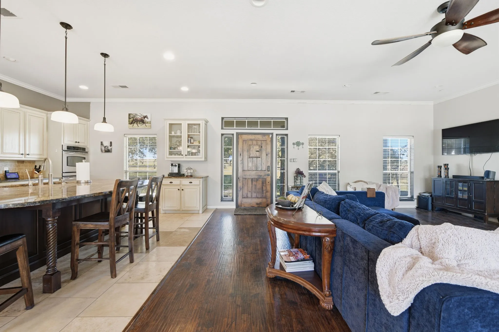 Living room featuring ornamental molding, recessed lighting, ceiling fan, and light wood-type flooring