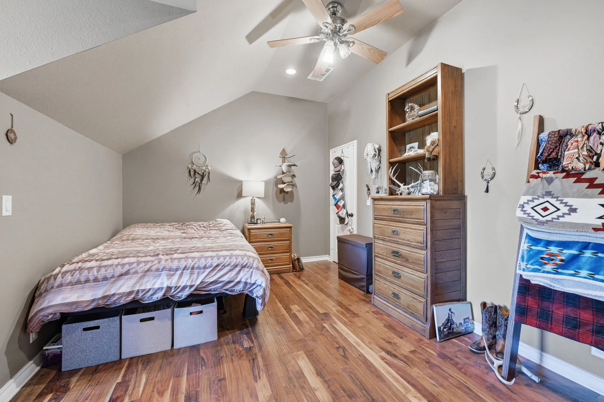 Bedroom featuring lofted ceiling, wood finished floors, a ceiling fan, and recessed lighting