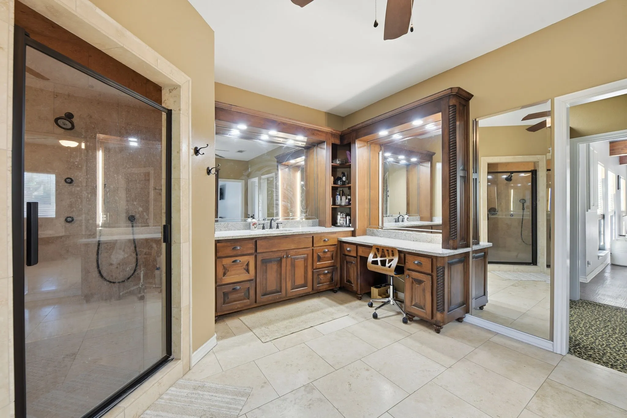 Bathroom with vanity, ceiling fan, a shower stall, and light tile patterned flooring