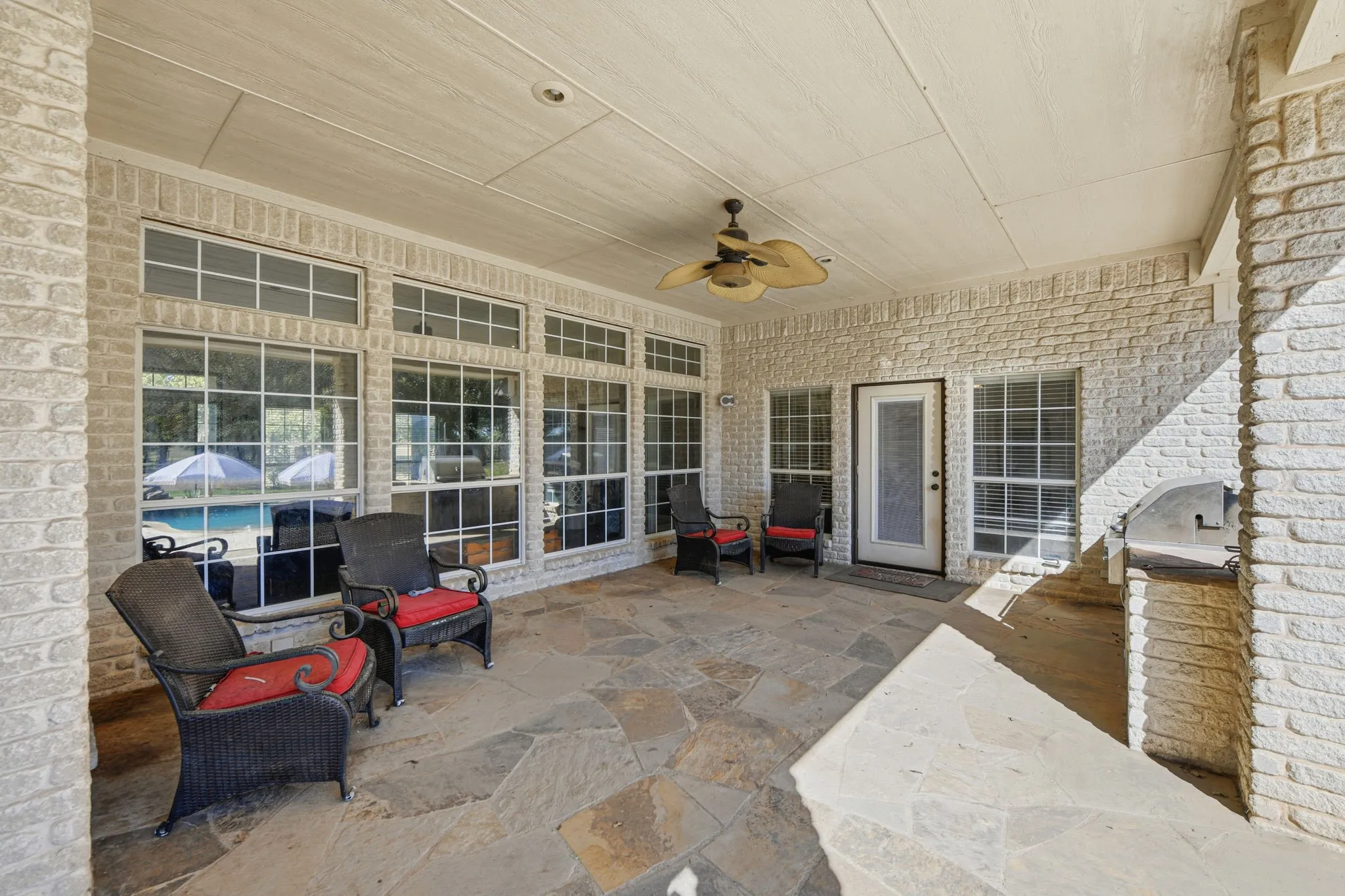 View of patio with a ceiling fan and exterior kitchen
