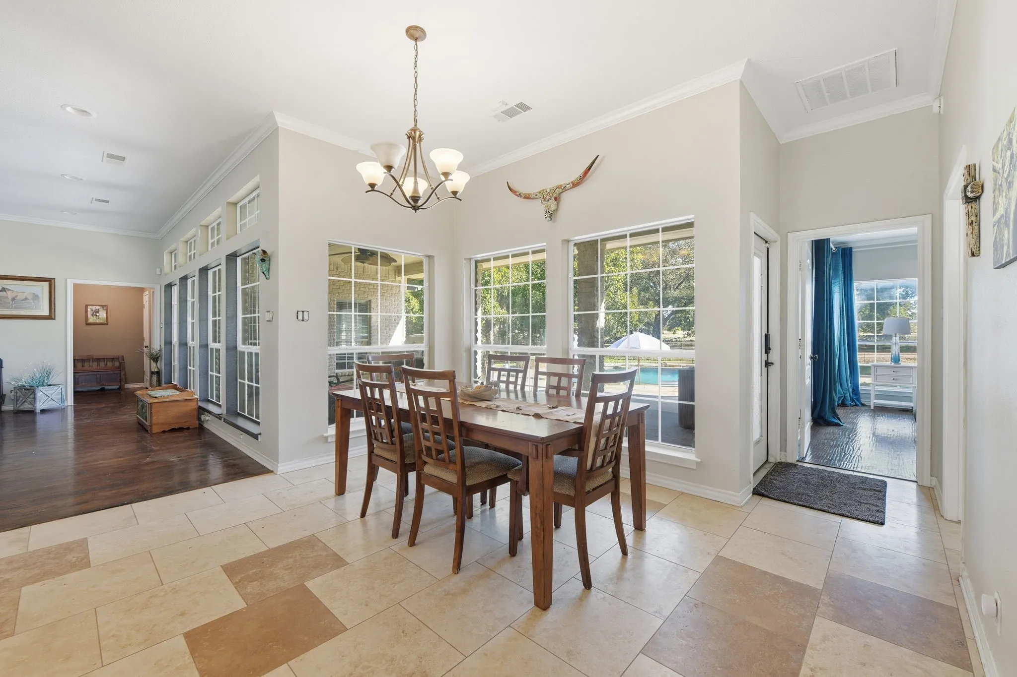 Dining area featuring ornamental molding and a chandelier
