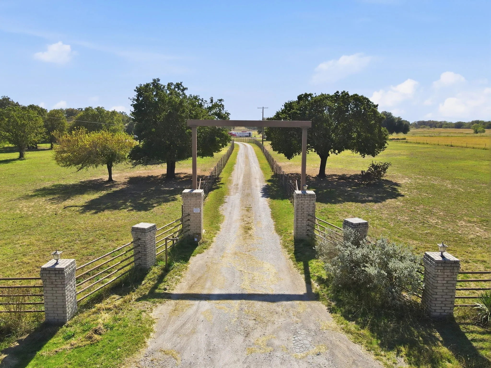 View of property's community with dirt driveway and a view of rural / pastoral area