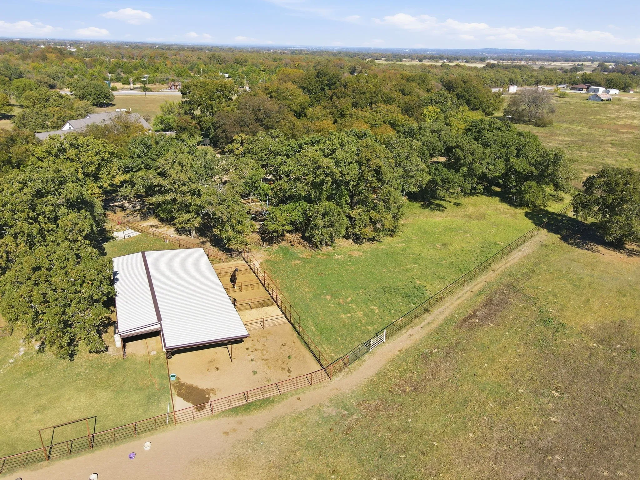 Aerial view of sparsely populated area featuring a pastoral area
