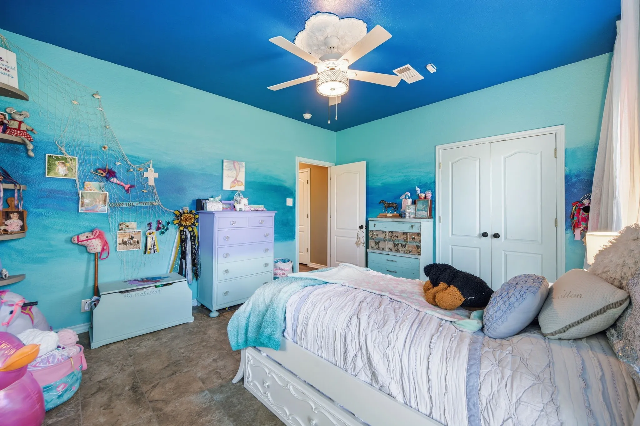 Bedroom featuring a closet, stone finish flooring, and a ceiling fan
