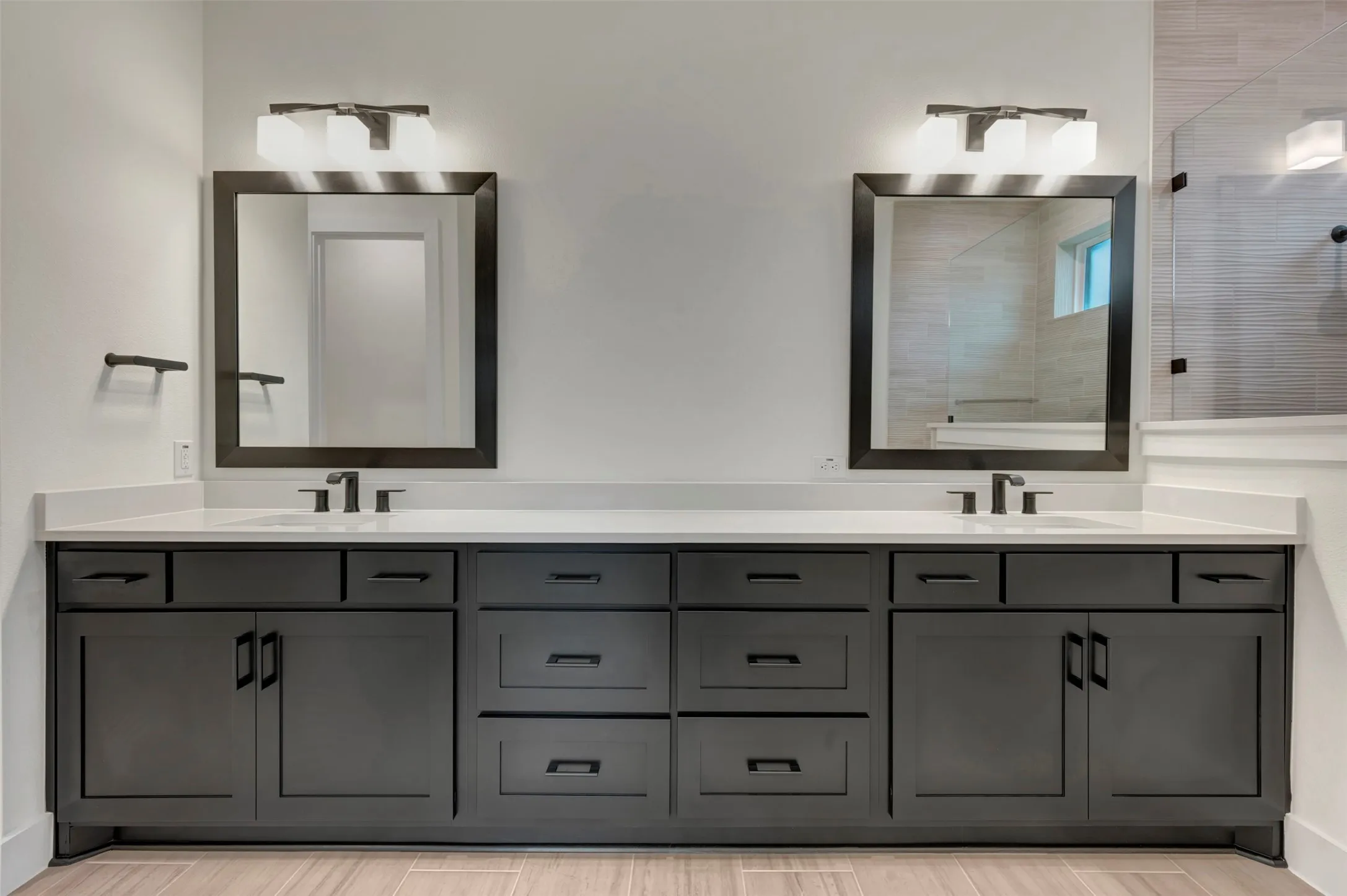 Owners bath featuring double vanity and a tile shower