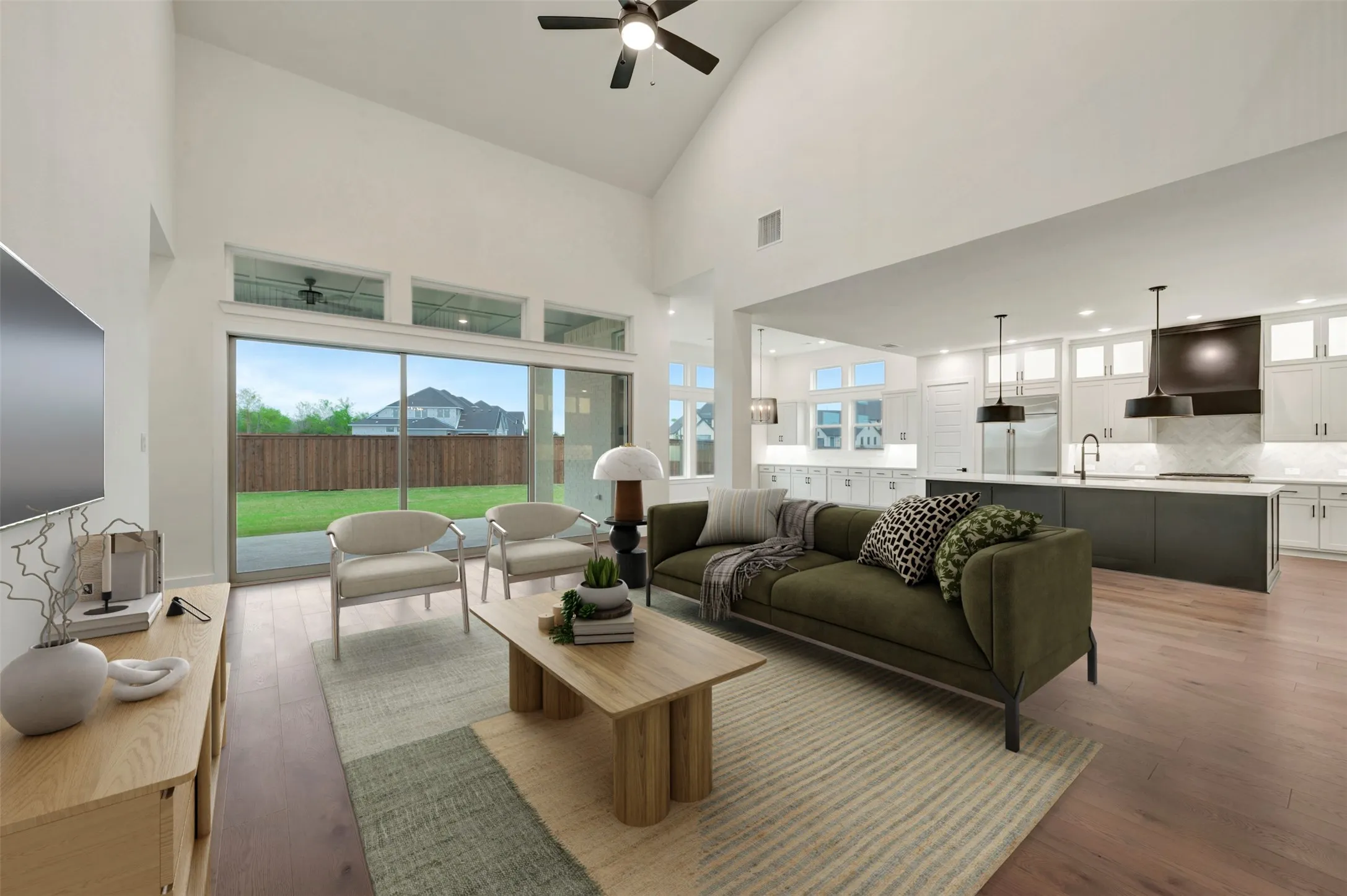 Living room with hardwood / wood-style floors, a ceiling fan, and lofted ceiling