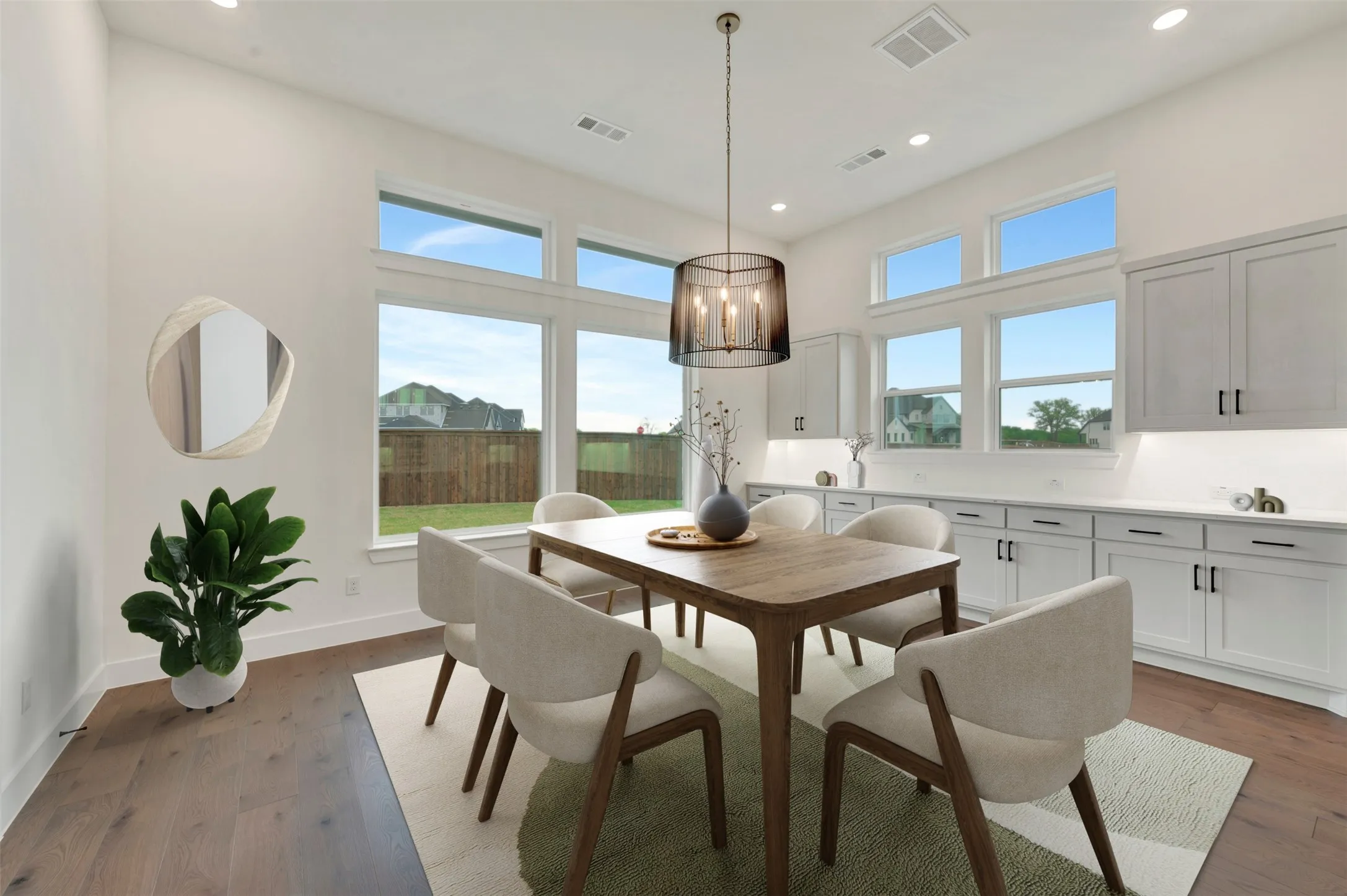 Dining space with dark wood finished floors and suspended lighting