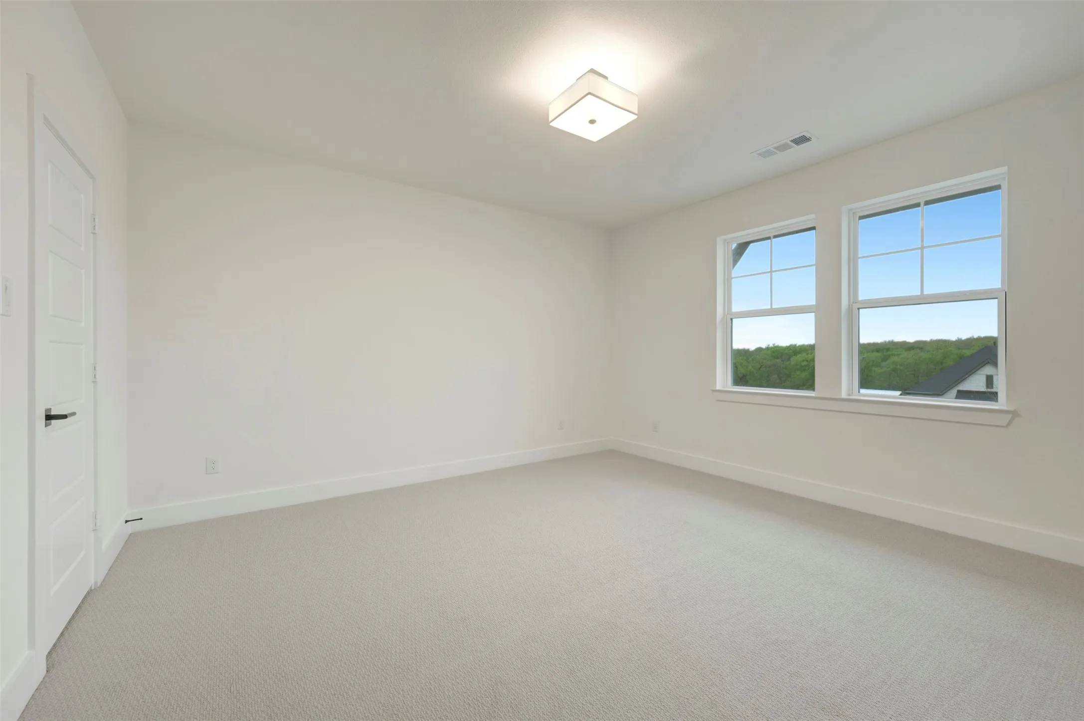 Unfurnished bedroom featuring carpet and baseboards