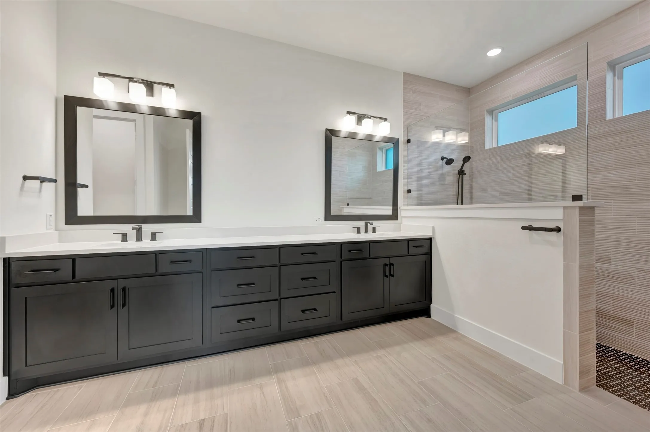 Owners Bath  featuring double vanity and a walk in shower