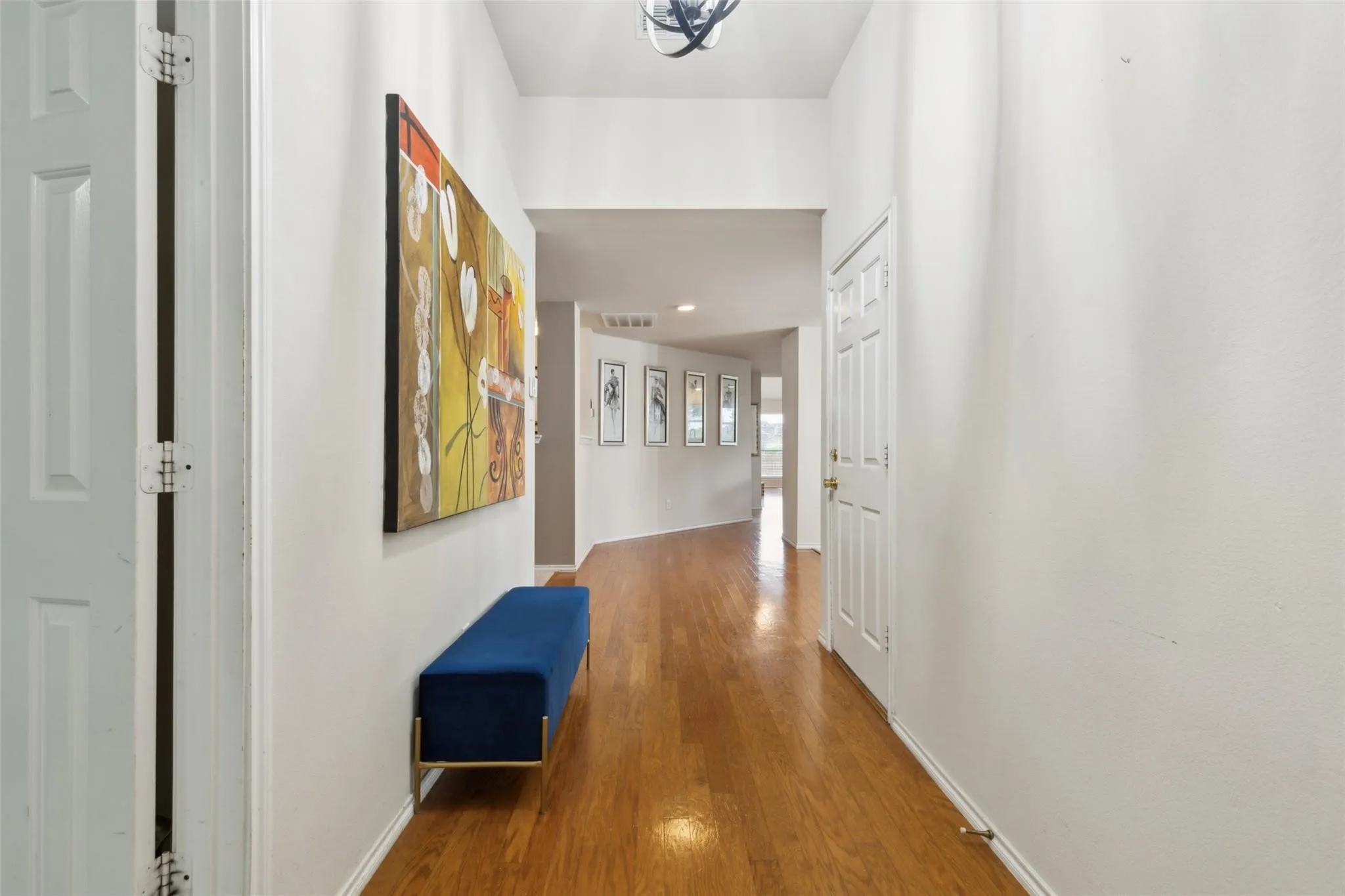 Hall featuring wood finished floors and baseboards