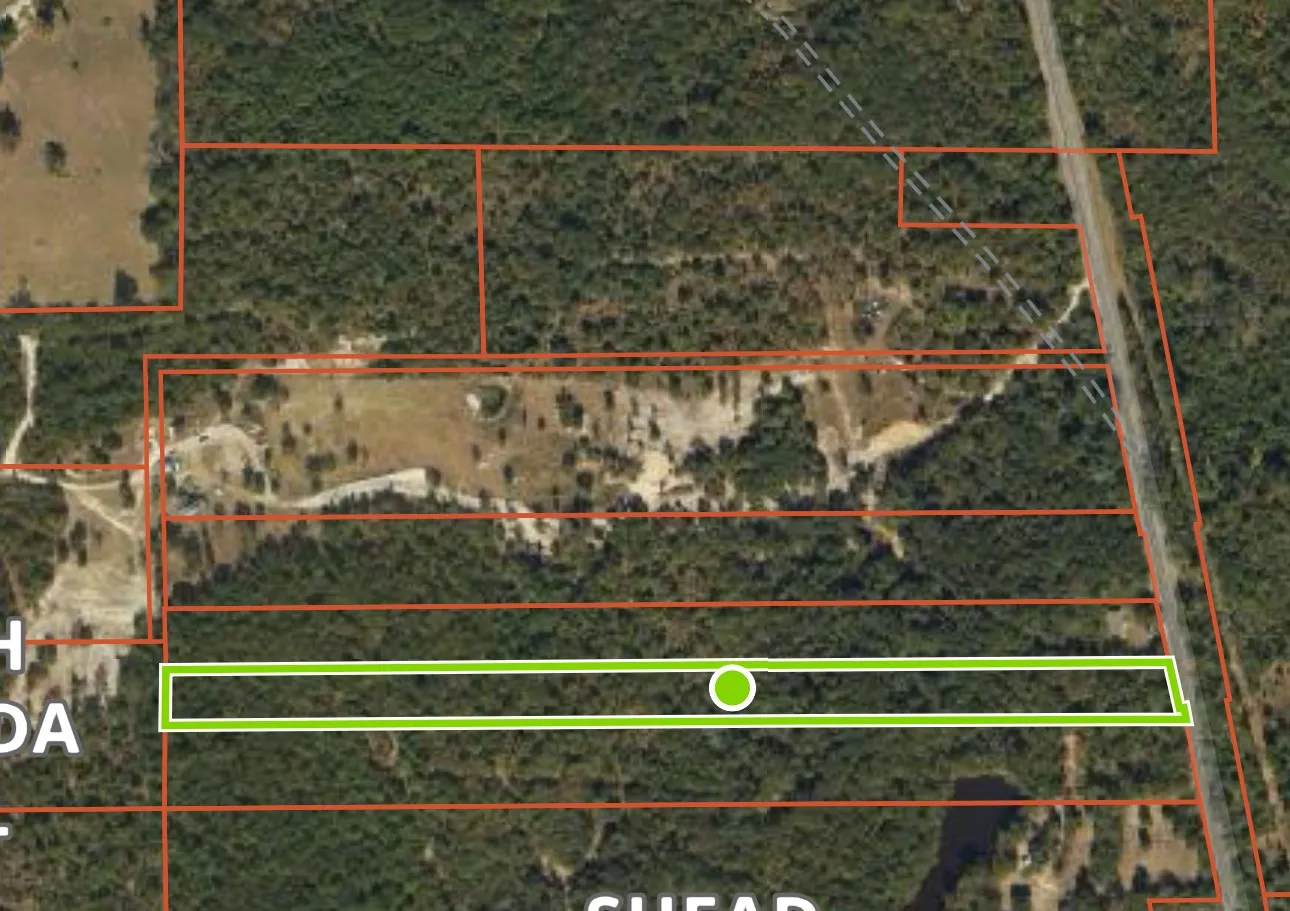 Aerial map of property and surrounding area featuring property parcel outlined