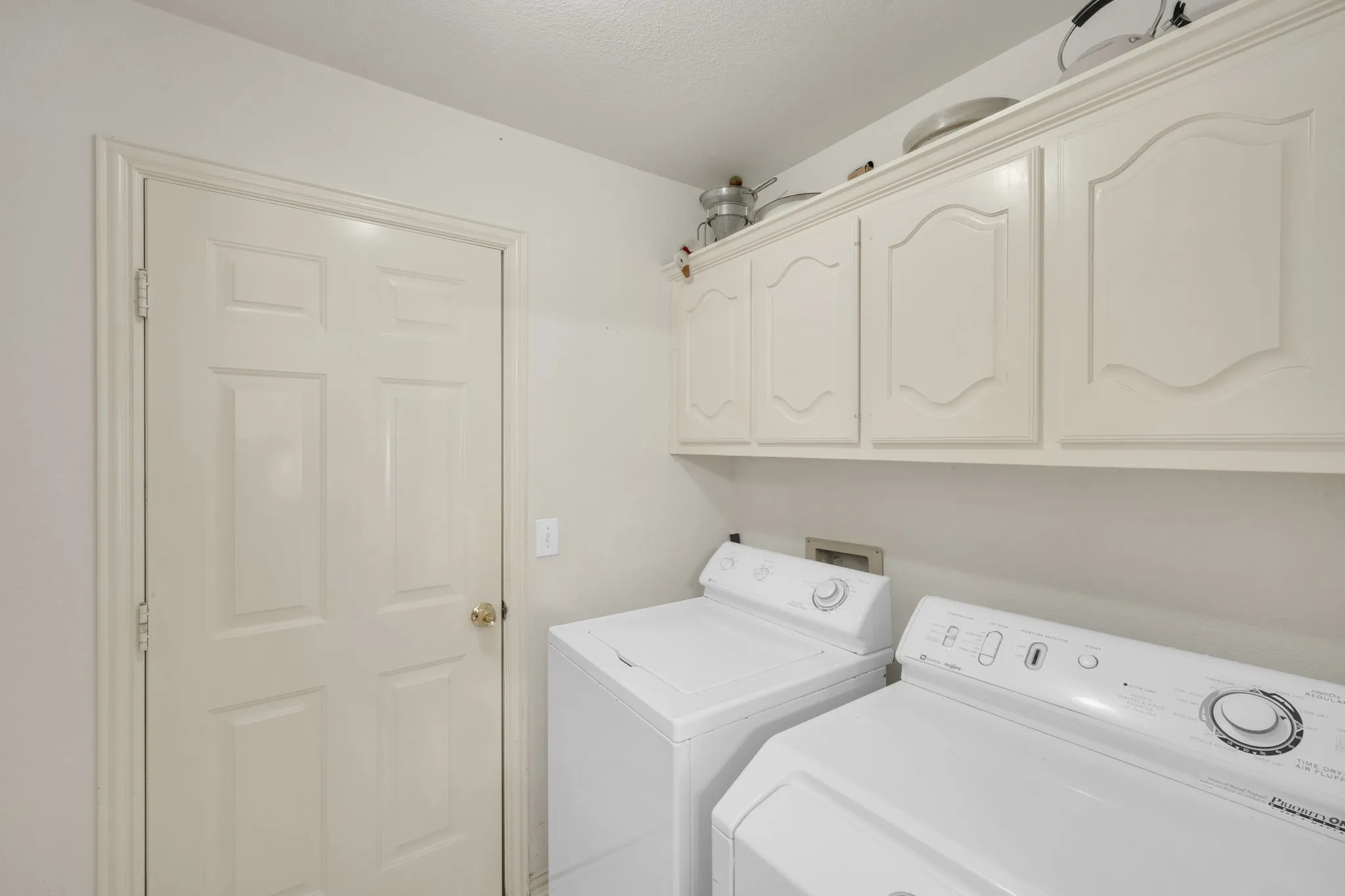 Laundry room with cabinet space and independent washer and dryer