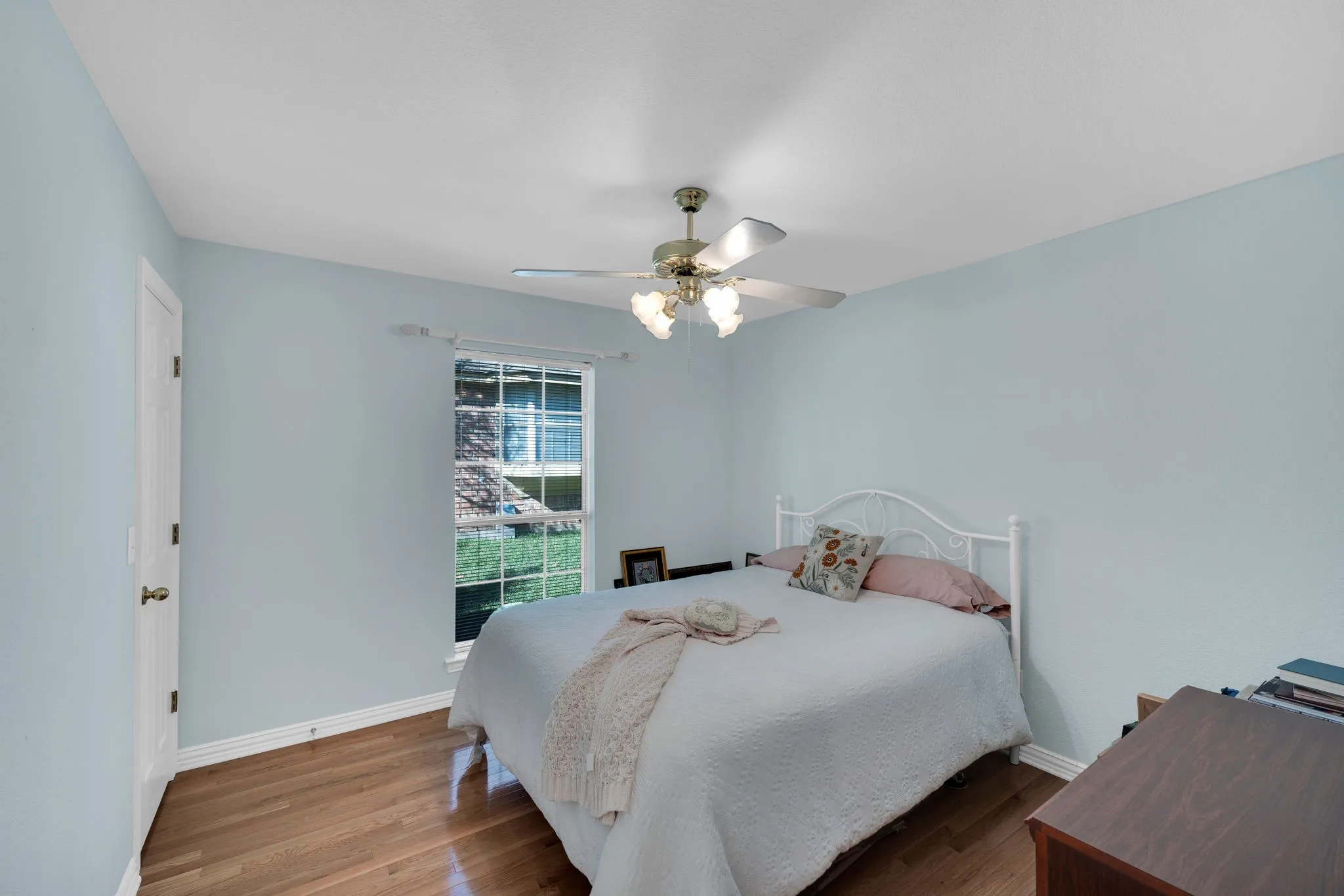 Bedroom with wood finished floors and ceiling fan