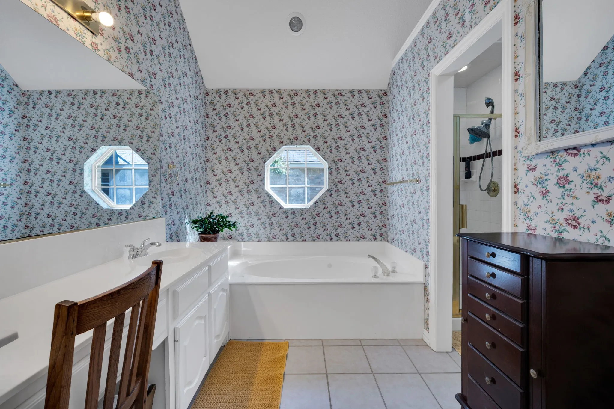 Bathroom with a garden tub, light tile patterned flooring, vanity, and a shower stall
