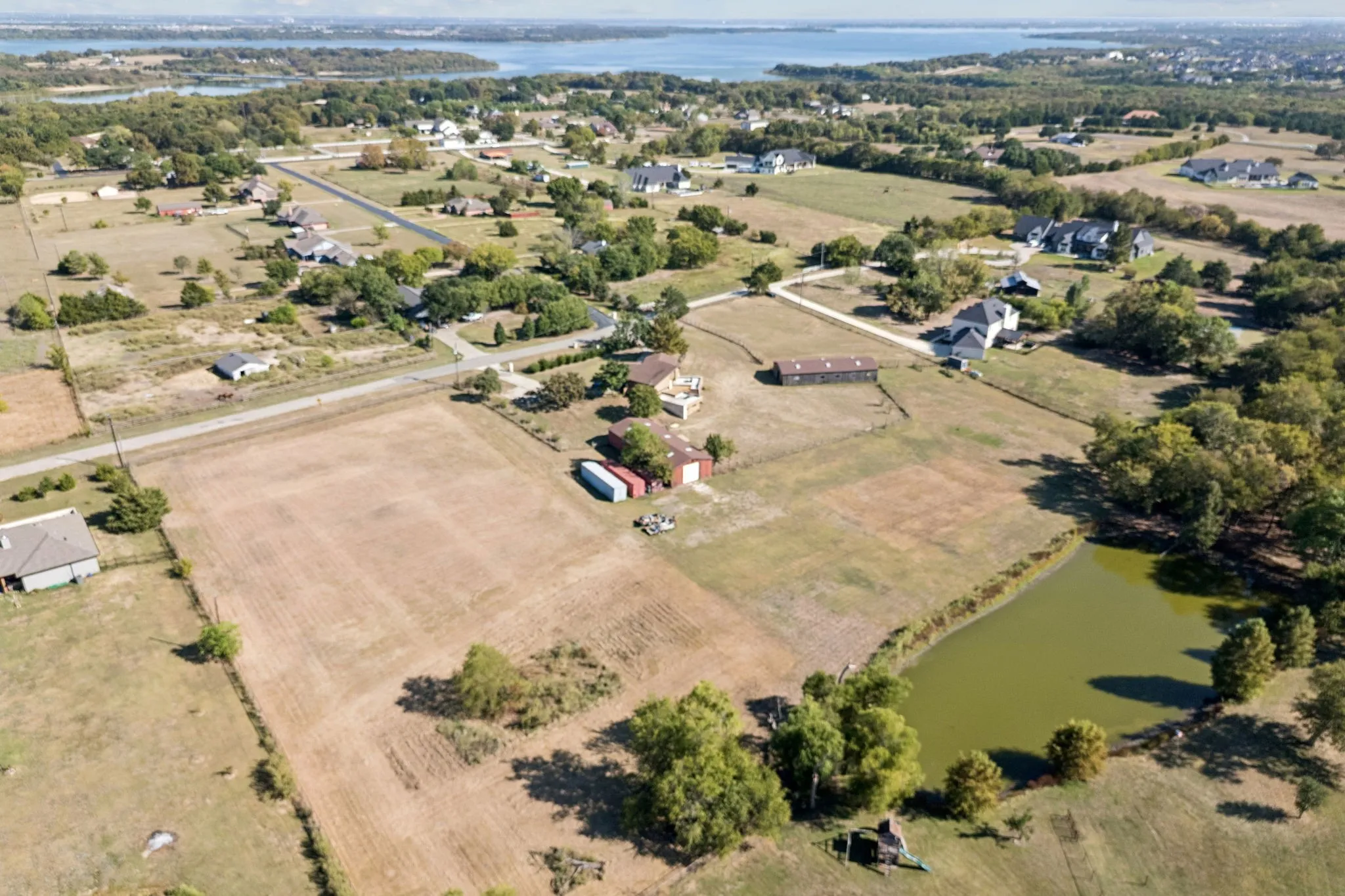 2.1 acre parcel is on the left of the red barn in this pictures.    An additional 3.75 acres is available for purchase with 2 barns and a house