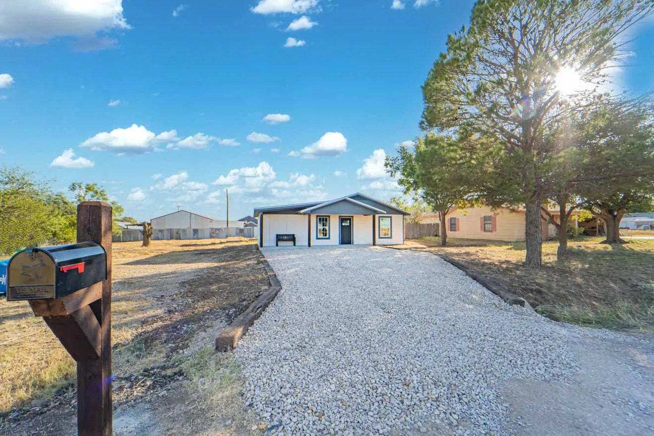 View of front of house featuring covered porch and driveway